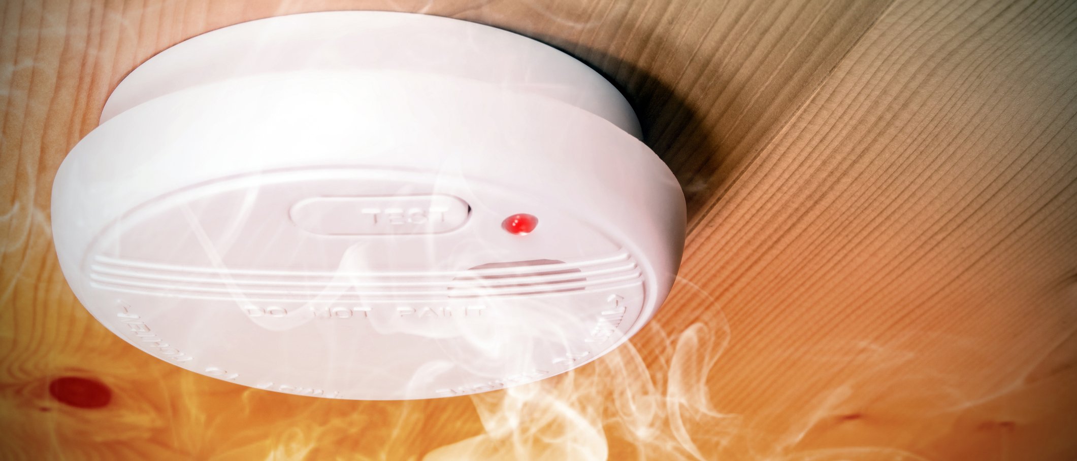 Close up of a white smoke alarm detecting smoke