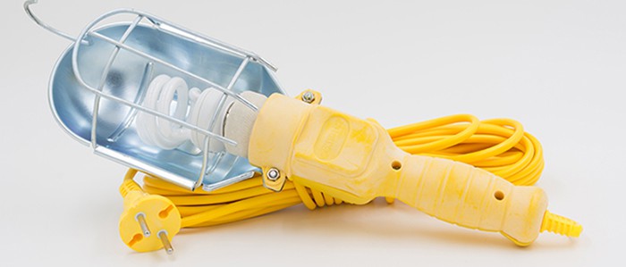 Yellow portable light fixture with long wire posing a hazard