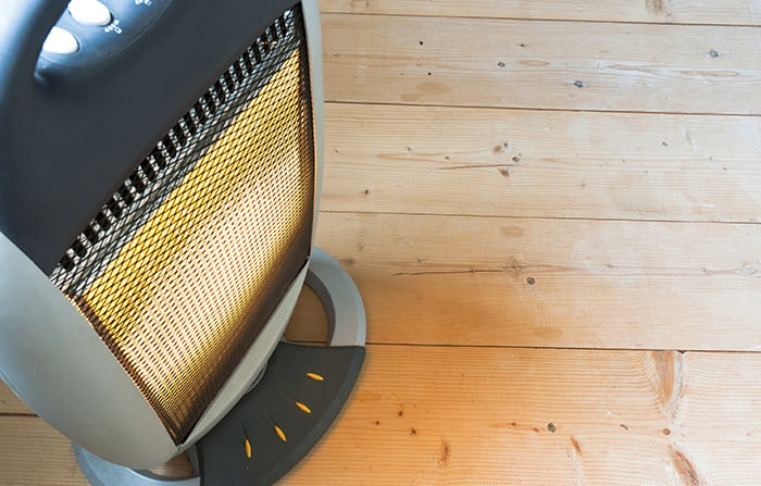 Top view of a space heater on wooden floor