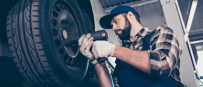 Tire dealer fixing car tire