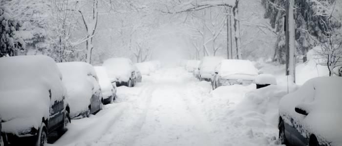 Parked cars buried in snow