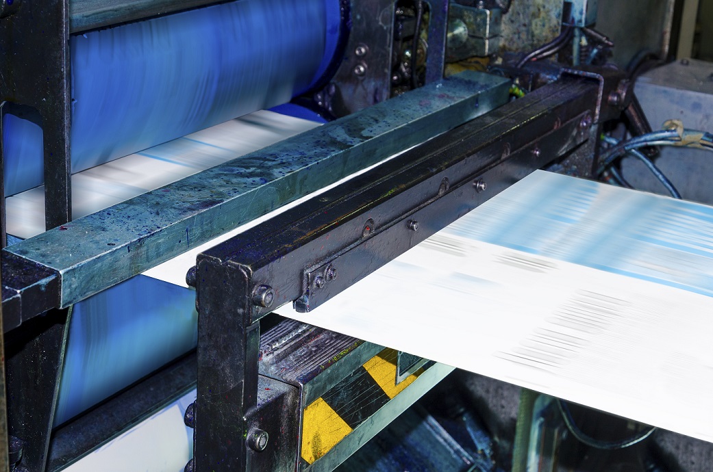 Machine printing posters at print shop