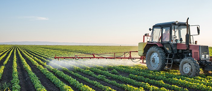 A Canadian farmer attending his agricultural crops with his truck