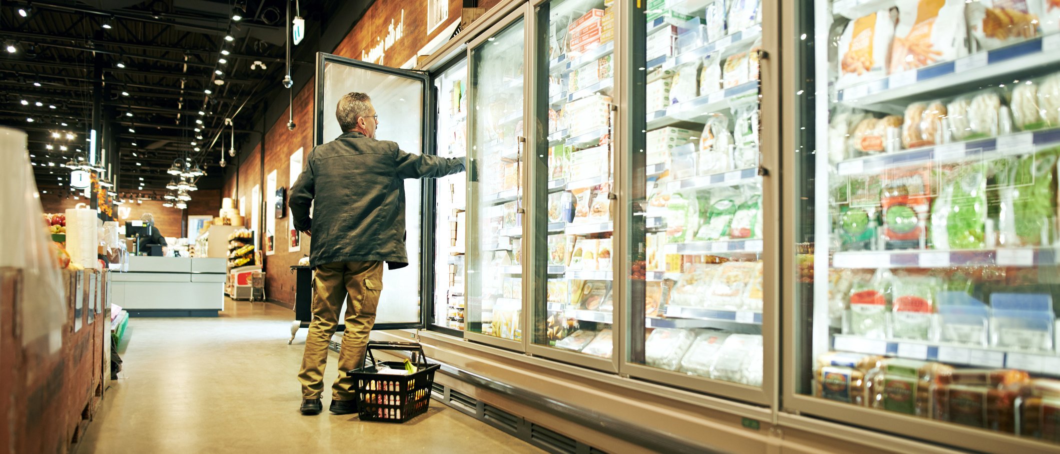 Shot of a mature man shopping in the cold produce section of a supermarket.