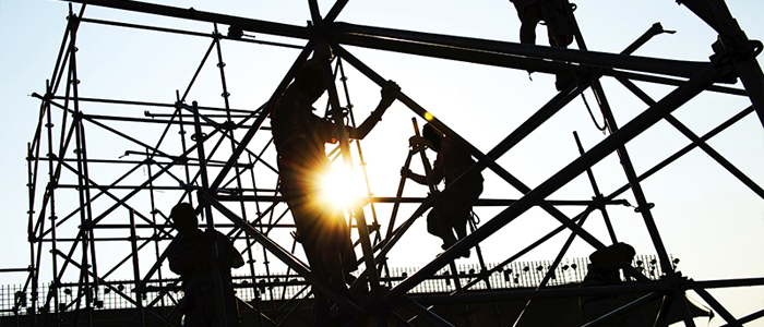 Construction workers working high up on a building