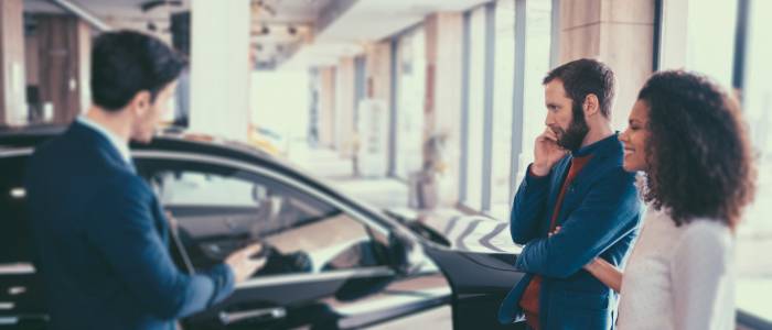 Dealer selling car at dealership