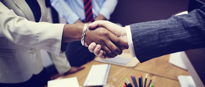Male and female business owners shaking hands with each other