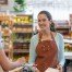 Grocery store staff greeting and cashing out customer
