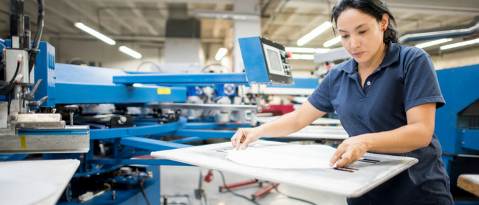 Female factory worker packing a parcel for delivery