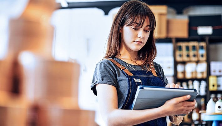 Female business women checking inventory on tablet 