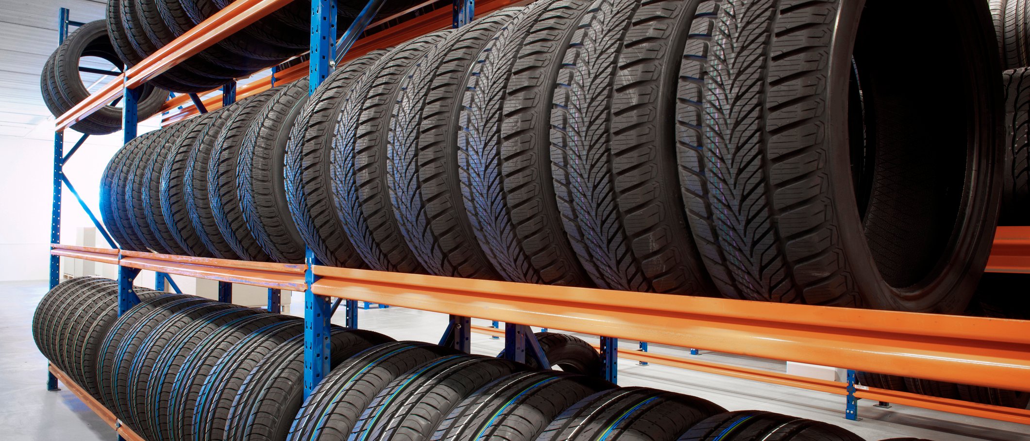 Black tires stored on shelf in warehouse