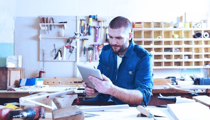 Male contractor browsing on tablet