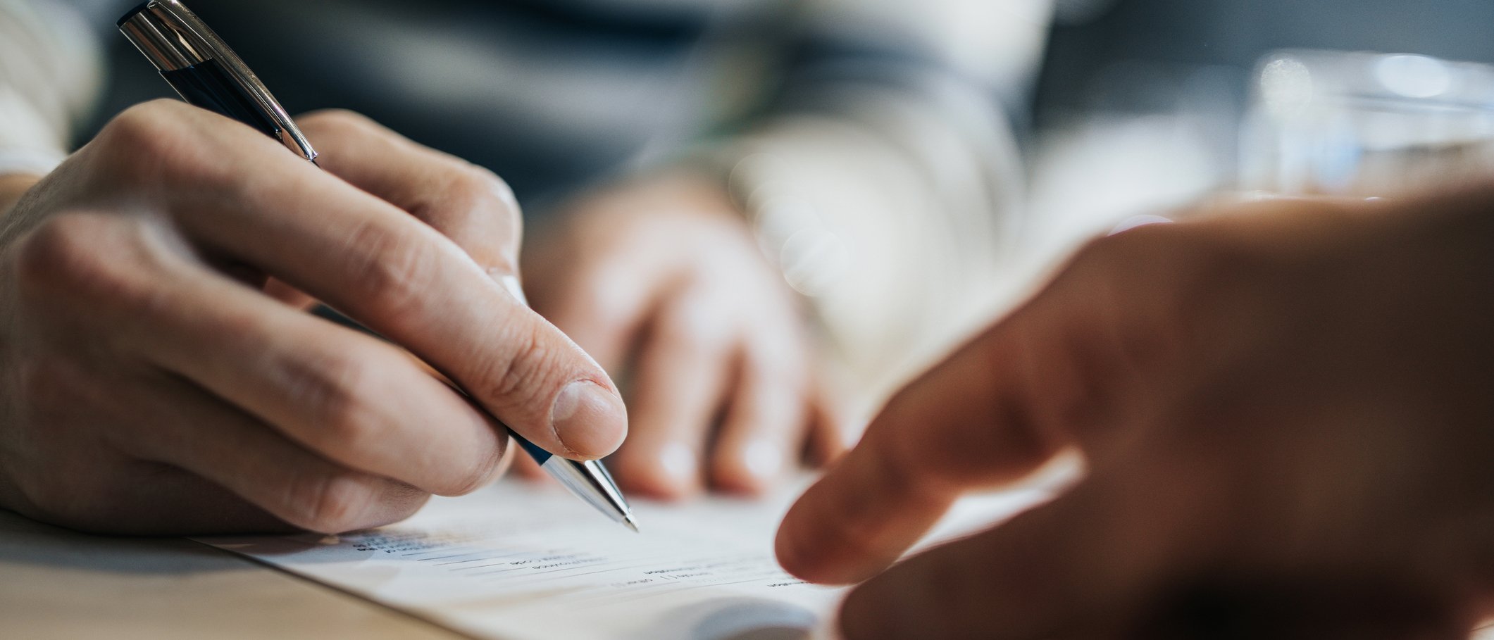 A business owner signing an insurance policy.