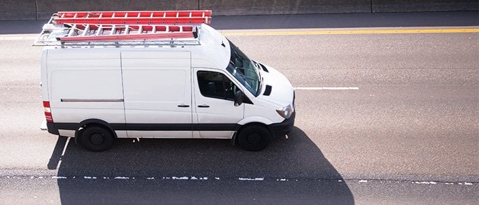 Commercial cargo van driving on road