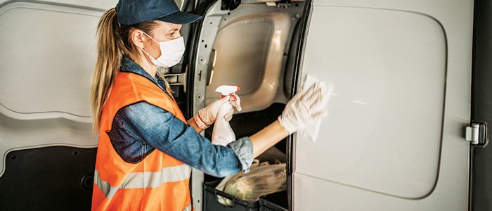 Female driver cleaning van