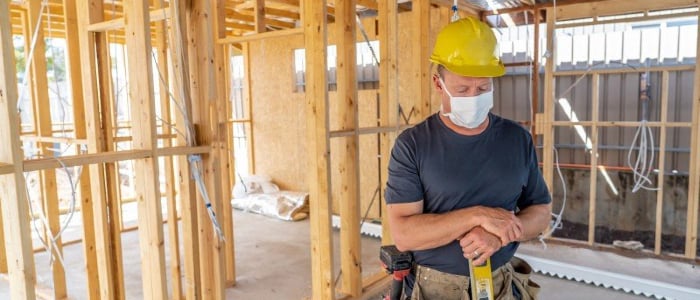 Male construction worker with mask on