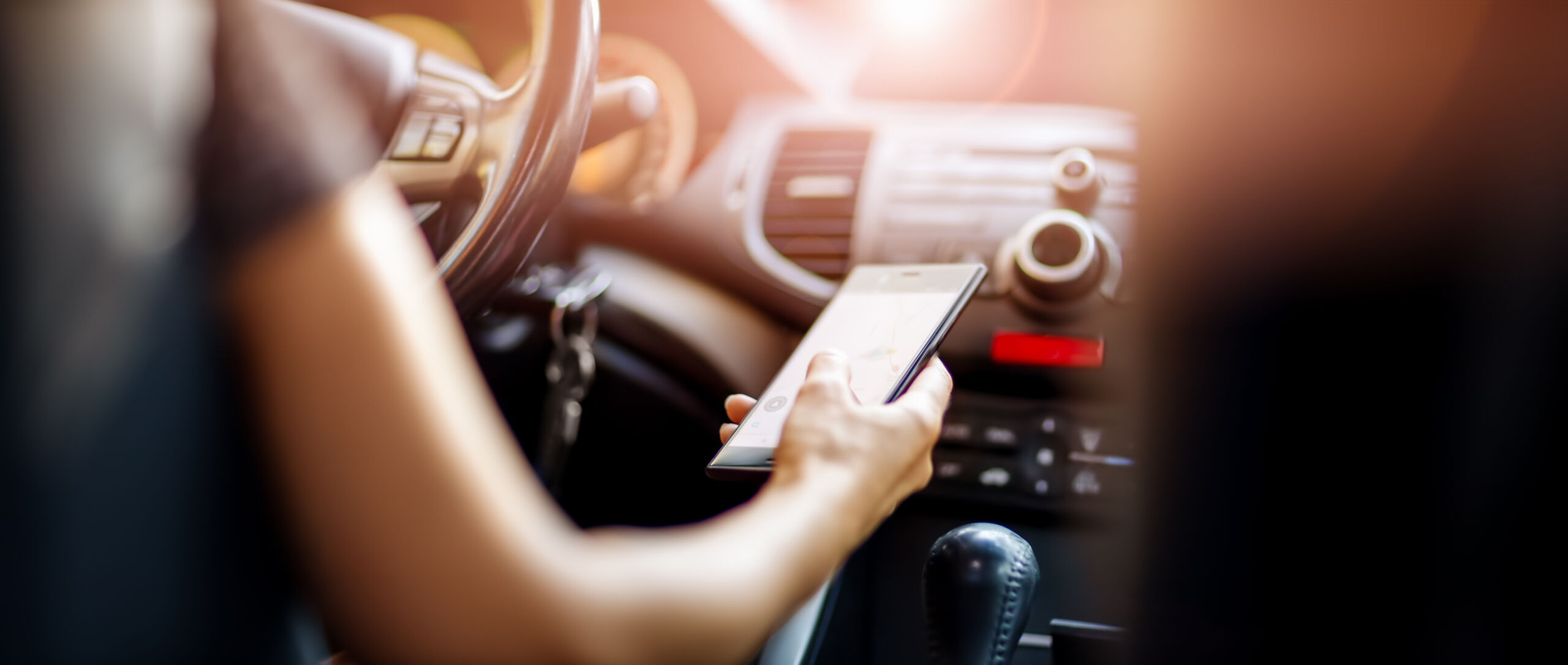 woman on cell phone while driving