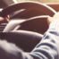 person behind the wheel of a car